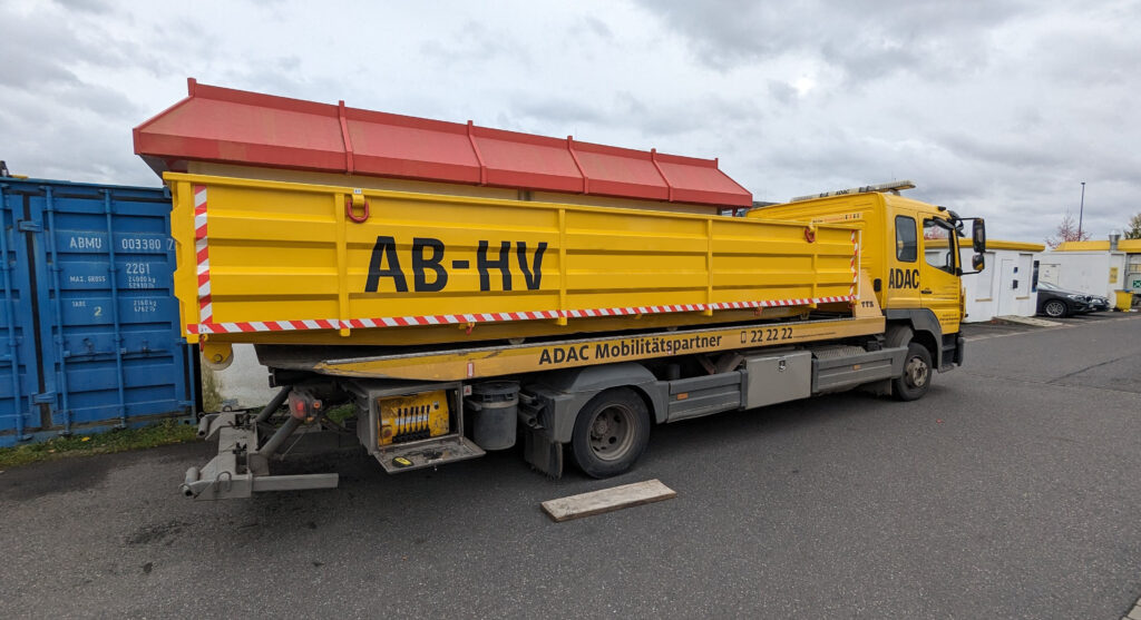 EV quarantine container loaded on a towing truck